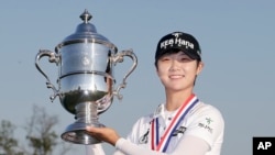 South Korea's Sung Hyun Park holds up the championship trophy after winning the U.S. Women's Open Golf tournament, July 16, 2017.