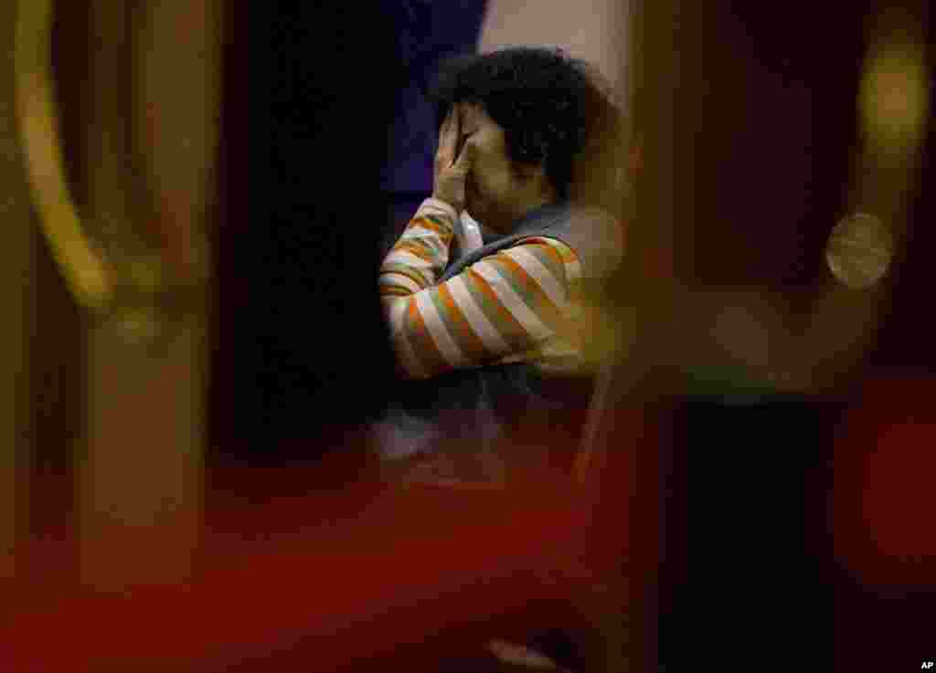 A relative of Chinese passengers aboard the missing Malaysia Airlines Flight MH370 waits for a briefing at a hotel ballroom in Beijing, March 18, 2014. 