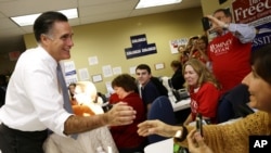 Republican presidential candidate Mitt Romney greets campaign workers during a visit to a voter call center in Green Tree, Pennsylvania, November 6, 2012.