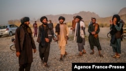 Taliban members enjoy a traditional dance on the banks of a river in Kandahar, September 23, 2021.