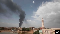 FILE - Smoke rises over Khartoum, Sudan, Thursday, June 8, 2023, as fighting between the Sudanese army and paramilitary Rapid Support Forces continues. 