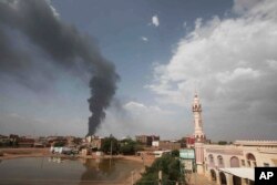 FILE - Smoke rises over Khartoum, Sudan, Thursday, June 8, 2023, as fighting between the Sudanese army and paramilitary Rapid Support Forces continues.
