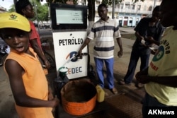 People buy kerosene for cooking and lighting at a gas station in Sao Tome, the capital of Sao Tome & Principe in West Africa's Gulf of Guinea, Nov. 4, 2006.