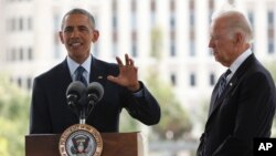 President Barack Obama, accompanied by Vice President Joe Biden, right, speaks at a memorial in honor of people killed in the shooting at a gay nightclub, in Orlando, Fla., June 16, 2016.