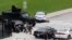 Police officers take cover near Parliament Hill following a shooting incident in Ottawa, October 22, 2014.