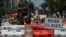 FILE - Construction workers repair a street near the White House in Washington, DC, on Aug. 10, 2021.