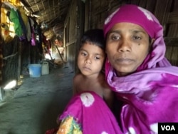 Rohingya refugee woman Noor Ayesha and her 5-year-old daughter at a Rohingya colony in Cox's Bazar, Bangladesh. "[During the military operation] the soldiers burnt alive my five children. They raped my two other daughters in front of me, before killing them. They also shot dead my husband...I shall never return to this country which is a hell for all Rohingyas," Ayesha told VOA. (S. Ullah/VOA)