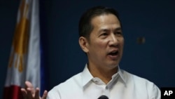 Philippine Foreign Affairs Department spokesman Raul Hernandez gestures as he answers questions from reporters during a press conference at Foreign Affairs headquarters in suburban Pasay, south of Manila, Philippines, Feb. 25, 2014. 