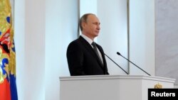 FILE - Russia's President Vladimir Putin delivers his annual state of the union address to the Federal Assembly at the Kremlin in Moscow, Dec. 4, 2014.