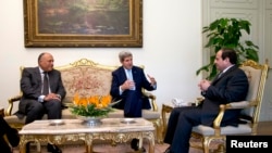 FILE - Egypt's President Abdel Fattah al-Sisi, right, and Foreign Minister Sameh Shoukry, left, meet with U.S. Secretary of State John Kerry at Cairo’s presidential palace Oct. 13, 2014. 