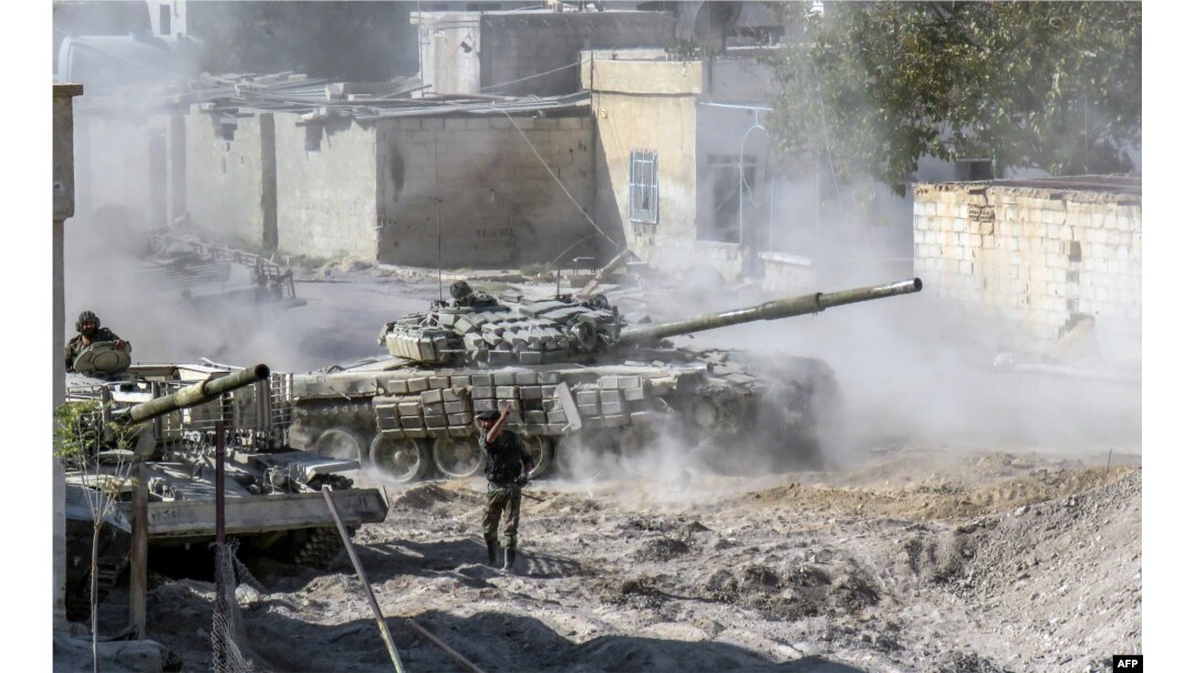 A Syrian Army modified T-72 tank drives during Syrian forces' assault to capture the rebel-held village of Hawsh Nasri, which is located near the rebel-held town of Douma on the eastern outskirts of the capital Damascus, Nov. 22, 2016.