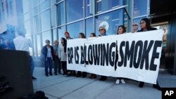 Activists from ProgressNow Colorado, grassroots organizations and stakeholders join forces to demonstrate outside the United States headquarters of BP, Nov. 14, 2018, in Denver.