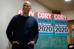 FILE - U.S. Sen. Cory Booker, D-N.J., waits as he is introduced to speak to local residents at the First Congregational United Church of Christ, Feb. 8, 2019, in Mason City, Iowa.