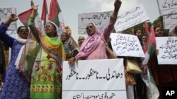 Supporters of Muttahida Qaumi Movement-Pakistan, a political party, protest the results of the recently concluded general elections, Aug. 2, 2018. The protesters demanded the resignation of the chief election commissioner and raised concerns regarding the transparency of the election. Placard at bottom reads "rigging is unacceptable." 