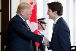 President Donald Trump welcomes Canadian Prime Minister Justin Trudeau outside the West Wing of the White House in February. Trudeau leaned in towards Trump and put his left hand near his shoulder.