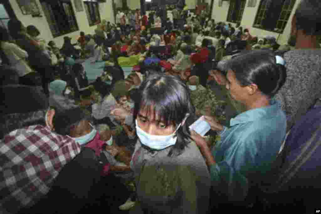 Villagers who live on the slope of Mount Merapi gather at a temporary shelter in Pakem, Yogyakarta, Indonesia, Tuesday, Oct. 26, 2010.