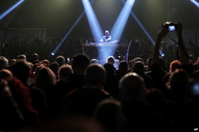 Roman Catholic priest Guilherme Peixoto plays a set, together with the Portuguese Army Symphonic Band, during Army Day celebrations in Viana do Castelo, northern Portugal, Thursday, Oct. 26, 2023. (AP Photo/Miguel Angelo Pereira)