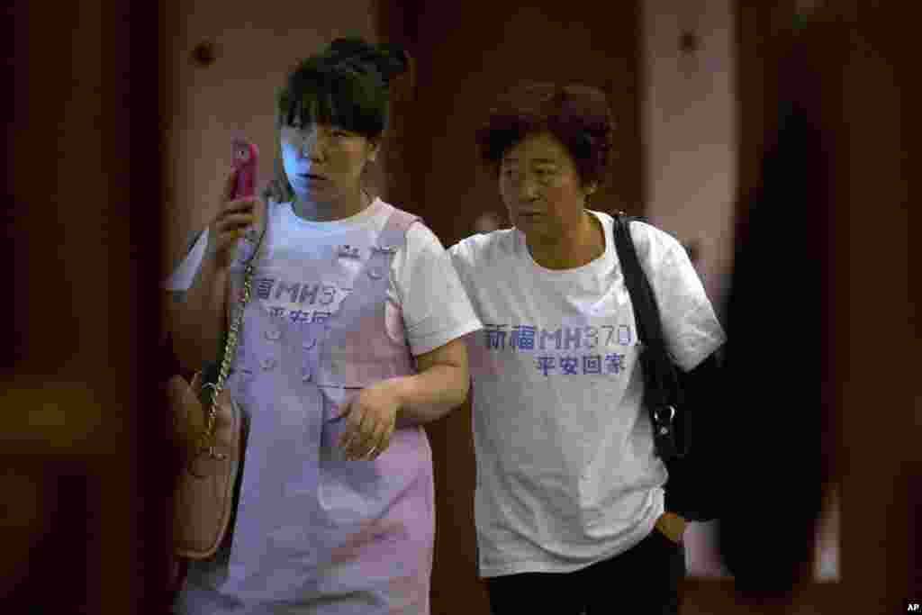 Relatives of Chinese passengers aboard missing flight MH370 leave a meeting room in a hotel in Beijing, March 23, 2014.