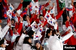 FILE - Athletes from North Korea and South Korea celebrate during the closing ceremony at the Pyeongchang 2018 Winter Olympics.