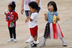 Children enjoy an early Fourth of July celebration in Jackson, Miss., June 26, 2020.