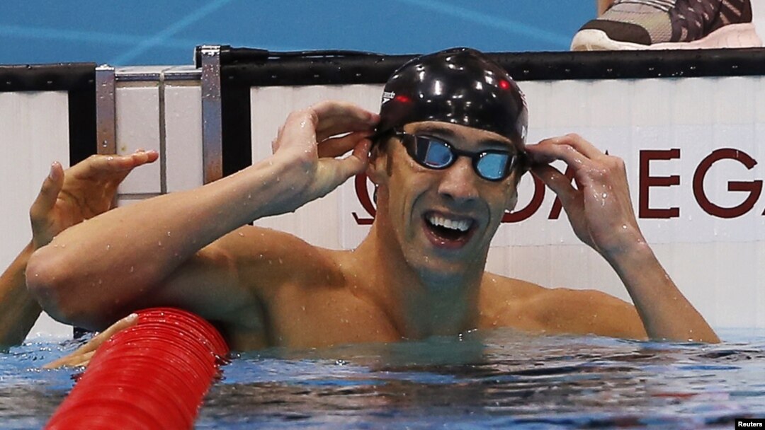 Michael Phelps of the U.S. celebrates winning gold in the men's 100m butterfly final during the London 2012 Olympic Games at the Aquatics Centre, August 3, 2012. 
