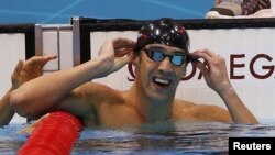 Michael Phelps of the U.S. celebrates winning gold in the men's 100m butterfly final during the London 2012 Olympic Games at the Aquatics Centre, August 3, 2012. 