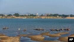 FILE - Fishing boats are moored in Mekong River, which has turned blue instead of its usual muddy color, in Nakhon Phanom province, northeastern Thailand, Dec. 4, 2019. 