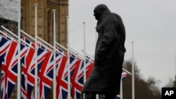 Bendera Inggris berkibar dekat patung Winston Churchill di luar gedung parlemen di London, 30 Januari 2020.