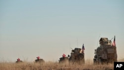 In this photo taken Nov. 1, 2018, Turkish and U.S. troops conduct joint patrols around the Syrian town of Manbij, as part of an agreement that aimed to ease tensions between the two NATO allies