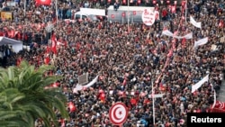 People carry flags as they protest the government's refusal to raise wages in Tunis, Tunisia, Nov. 22, 2018. The country's biggest union called a nationwide strike Thursday in protest.
