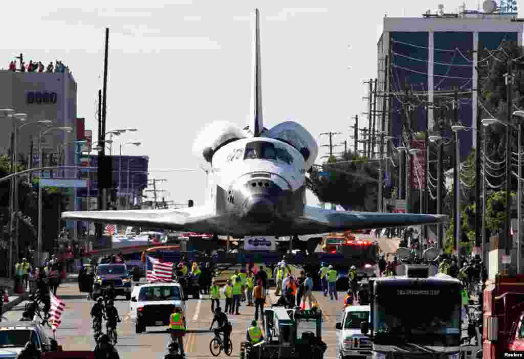 October 12: The Space Shuttle Endeavour is transported from Los Angeles International Airport to its retirement home at the California Science Center in Exposition Park in Los Angeles, California.