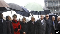Palestinian President Mahmoud Abbas, center, stands on a podium with UNESCO director general Irina Bokova, fourth from left, and other UNESCO and Palestine government officials in Paris, December 13, 2011.