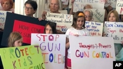 Supporters of gun control measures are seen gathered at the Legislative Office Building in Concord, New Hampshire, Aug. 5, 2019, urging Republican Governor Chris Sununu to sign them in the wake of two mass shootings in Texas and Ohio over the weekend. 