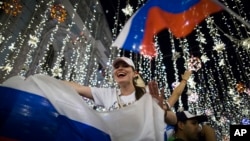 Russian soccer fans celebrate the national team victory after the group A match between Russia and Egypt during the 2018 soccer World Cup in Moscow, Russia, early on June 20, 2018.