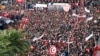 People carry flags as they protest the government's refusal to raise wages in Tunis, Tunisia, Nov. 22, 2018. The country's biggest union called a nationwide strike Thursday in protest.