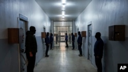 Guards stand in a corridor Syrian Democratic Forces-run Gweiran Prison, now called Panorama, which houses men accused of being Islamic State fighters in Hassakeh, northeastern Syria, Jan. 31, 2025. 