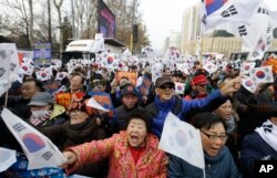 Supporters of impeached South Korean President Park Geun-hye shout slogans during a rally opposing her impeachment in Seoul, South Korea, Dec. 24, 2016.