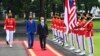 Malaysian Prime Minister Muhyiddin Yassin, center, walks with Indonesian President Joko Widodo as they inspect honor guards during their meeting at Merdeka Palace in Jakarta, Indonesia, Friday, Feb. 5, 2021. (Agus Suparto, Indonesian President Palace via AP)