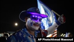 A pro-statehood New Progressive Party supporter waves his party's flag during their closing campaign rally in San Juan, Puerto Rico, November 3, 2012.