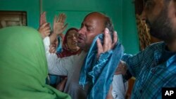 Abdul Gaffar mourns the killing of his son Manzoor Ahmed Bhat, April 6, 2018, who was abducted, and later killed by suspected militants, at his residence in Hajin, about 38 kilometers (24 miles) north of Srinagar, Indian-controlled Kashmir. Police say that anti-India militants have stormed two homes in the past few days in one Kashmiri town, dragging away two men and killing both of them. 