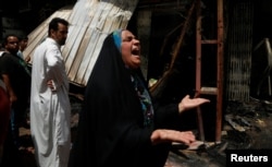 A woman reacts at the scene of a car bomb attack in Baghdad's mainly Shi'ite district of Sadr City, Iraq, May 11, 2016.