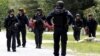 Law enforcement officials search a street near the Clinton Correctional Facility in Dannemora, New York, from which two convicts broke out about a week ago, June 10, 2015. 