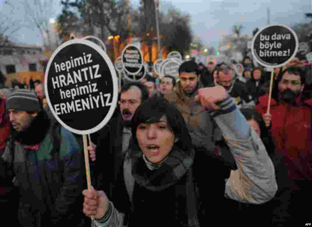 Hundreds of protesters hold placards that read 'We are all Armenians' as they shout slogans outside a courthouse in Istanbul, Turkey, Tuesday, Jan. 17, 2012. A Turkish court on Tuesday sentenced a man to life in prison for masterminding the killing of an 