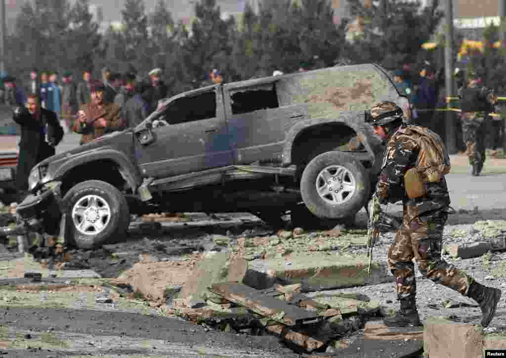 Afghan security forces inspect the site of a blast in Kabul.
