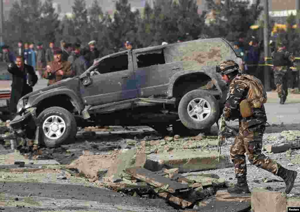 Afghan security forces inspect the site of a blast in Kabul.