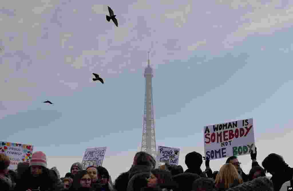 Protesters take part in a Women&#39;s March next to the Eiffel Tower, in Paris, France, Saturday, Jan. 21, 2017. The march is part of a worldwide day of actions following the inauguration of U.S President Donald Trump. (AP Photo/Christophe Ena)