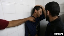 A relative of a Palestinian who was killed at the Israel-Gaza border reacts at a hospital, in the southern Gaza Strip, May 6, 2018. 