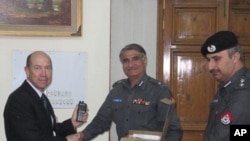 U.S. Assistant Secretary David Johnson and Embassy Islamabad Deputy Chief of Mission Gerald Feierstein donate communications equipment to the North Western Frontier Province police.