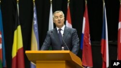FILE - Milo Djukanovic, Montenegro's prime minister at the time, speaks at a NATO Parliamentary Assembly session in Tirana, Albania, May 30, 2016.