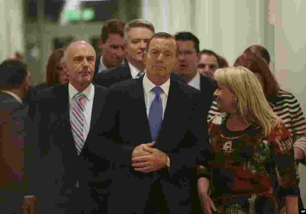 Australian Prime Minister Tony Abbott (center) leaves the Australian Liberal Party meeting in which he lost the party leadership at Parliament House in Canberra, Sept. 14, 2015.